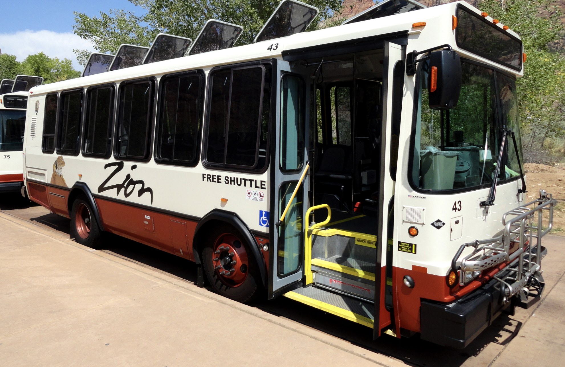 Zion Free Shuttle Bus Zion National Park free shuttle bus with open door, wheelchair access and a front mounted bike rack